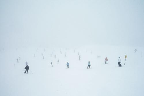 snow ghosts Winter sports Skiing Ski run Crowd of people Bad weather Fog Snow Cold White Ghostly Exterior shot Copy Space top Day Full Many Snowboarding Skier