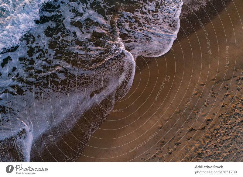 Aerial view of the shore of the beach Aircraft Beach Vantage point Ocean Top Coast Water Drone Summer Sunset Background picture Above Sand seascape Wave