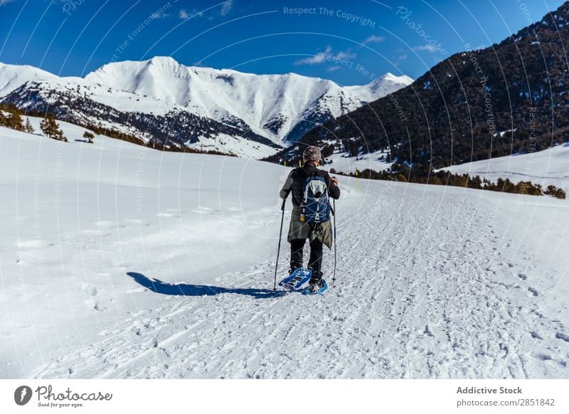 Man walking through the snow Snow Hiking Walking trekking White Winter Snow shoes Nature Lifestyle Mountain Action Cold Sky Climbing 2 Backpack snowshoe