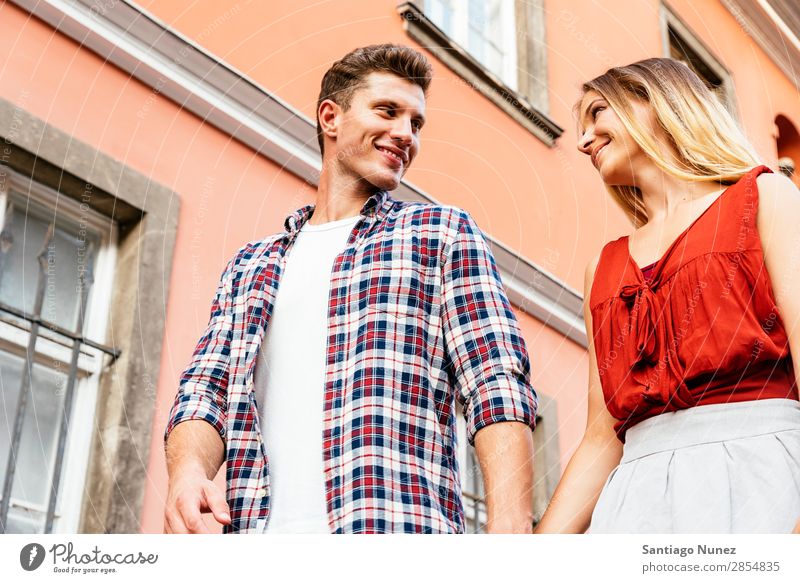 Romantic Young Couple Walking in the City. Relationship Love Youth (Young adults) Happy Laughter Smiling Human being Summer Street Europe Together Caucasian