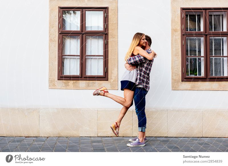 Young loving couple hugging in the street. Couple Love Woman Relationship Youth (Young adults) Beautiful Embrace Romance Joy Jump joying Happiness Kissing