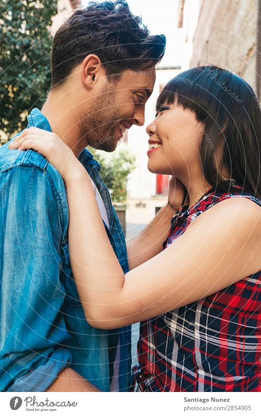 Portrait of happy beautiful couple isolated on street Adults Affection asian Attractive Boy (child) boyfried boyfriend Easygoing Caucasian Chinese Close-up