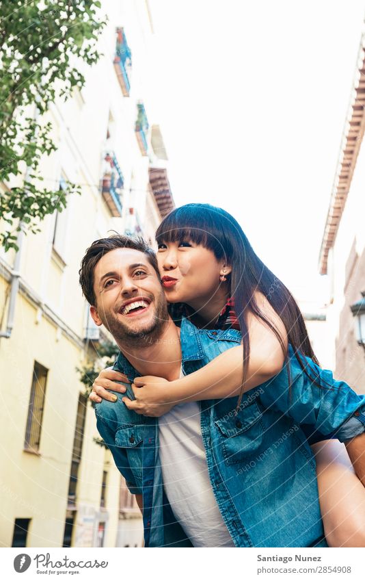 Happy loving couple. Happy young man piggybacking his girlfriend. asian Beautiful boyfriend Recklessness Cheerful Chinese City Couple Family & Relations