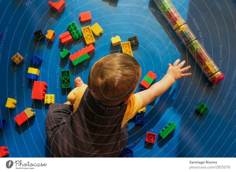 Happy baby playing with toy blocks. Baby Playing childcare Kindergarten School Toys Toddler Boy (child) Small Child LEGO Considerate Story Cute Joy Preschool