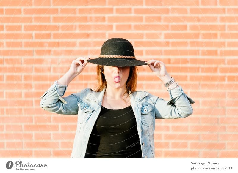 Blonde hipster posing with straw hat against orange brick background. Fashion Wall (building) Girl Hip & trendy Woman Youth (Young adults) Hipster Easygoing