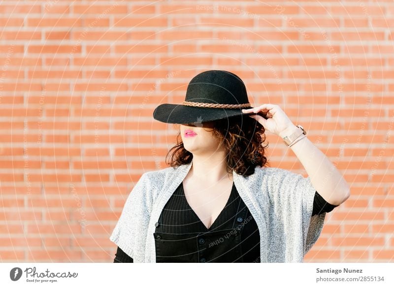 Blonde hipster posing with straw hat against orange brick background. Fashion Wall (building) Girl big size Hip & trendy Woman Youth (Young adults) Hipster