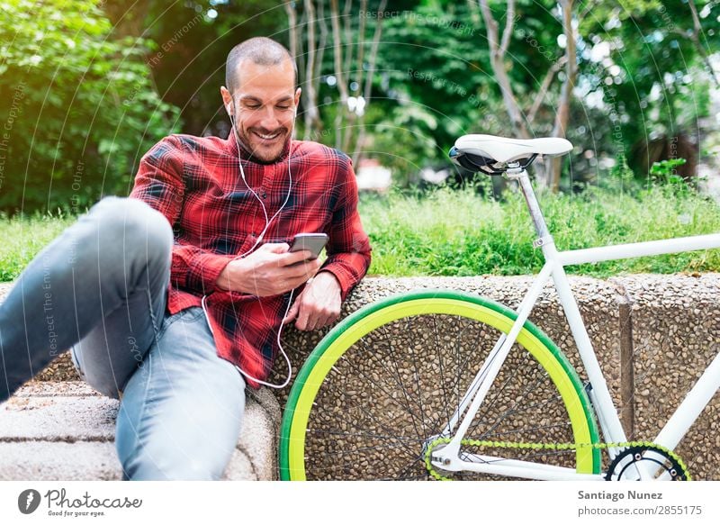 Young man with mobile phone and fixed gear bicycle Mobile Man Bicycle fixie Telephone Hipster Lifestyle Stand Cycling City Building Solar cell Town Human being