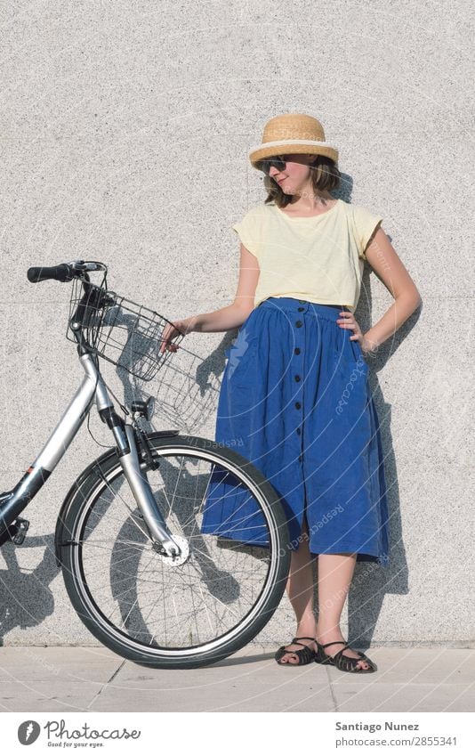 Young sexy blonde girl is standing near the bicycle Adults Background picture Bag Basket Beautiful Beauty Photography Bicycle Blonde Blue Brown Caucasian City