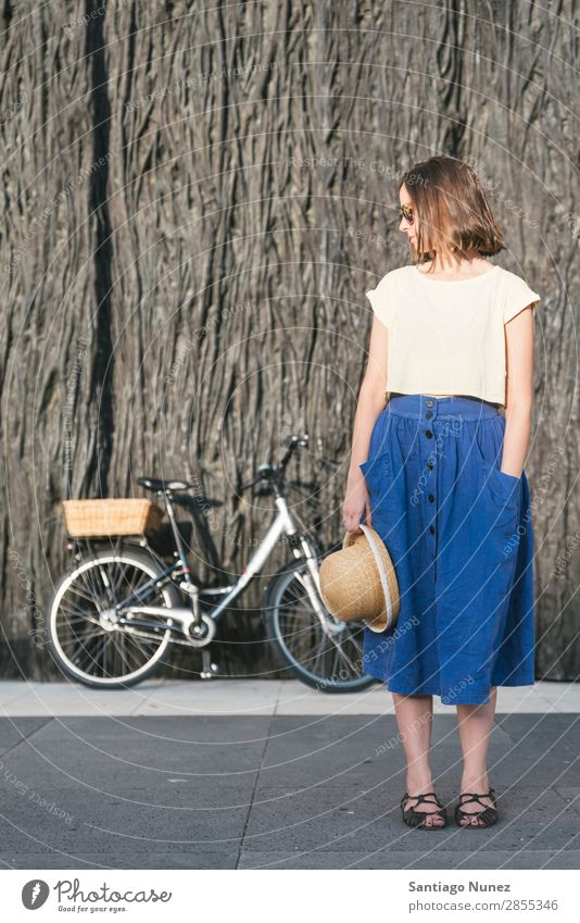 Young sexy blonde girl is standing near the bicycle Adults Background picture Bag Basket Beautiful Beauty Photography Bicycle Blonde Blue Brown Caucasian City