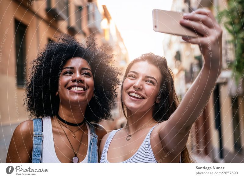 Beautiful women taking a self portrait in the Street. Woman Friendship Youth (Young adults) Happy Summer Human being Joy Mobile PDA Telephone Solar cell