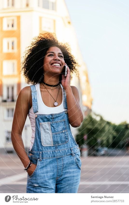 Beautiful woman using mobile in the Street. Woman Telephone Black African Mobile PDA speaking Afro Human being Portrait photograph City Youth (Young adults)