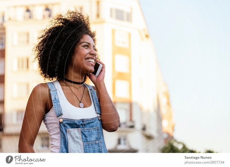 Beautiful woman using mobile in the Street. Woman Telephone Black African Mobile PDA speaking Afro Human being Portrait photograph City Youth (Young adults)