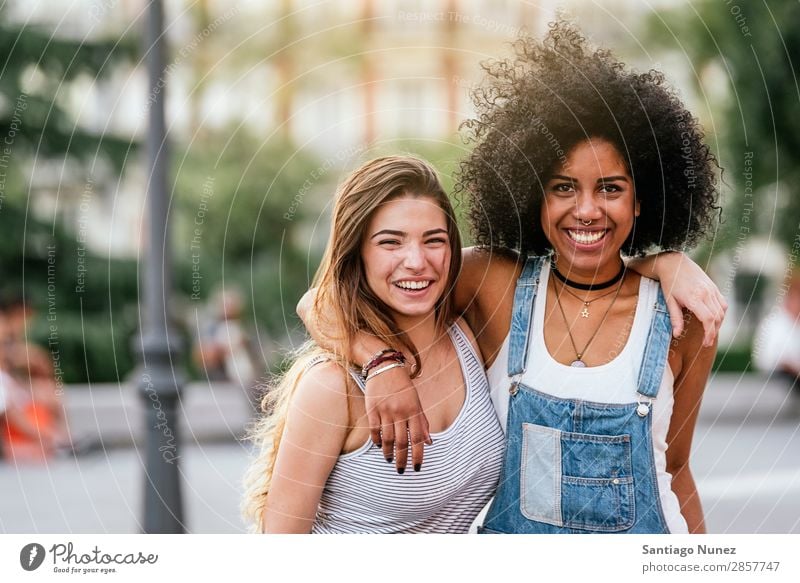 Beautiful women having fun in the street. - a Royalty Free Stock