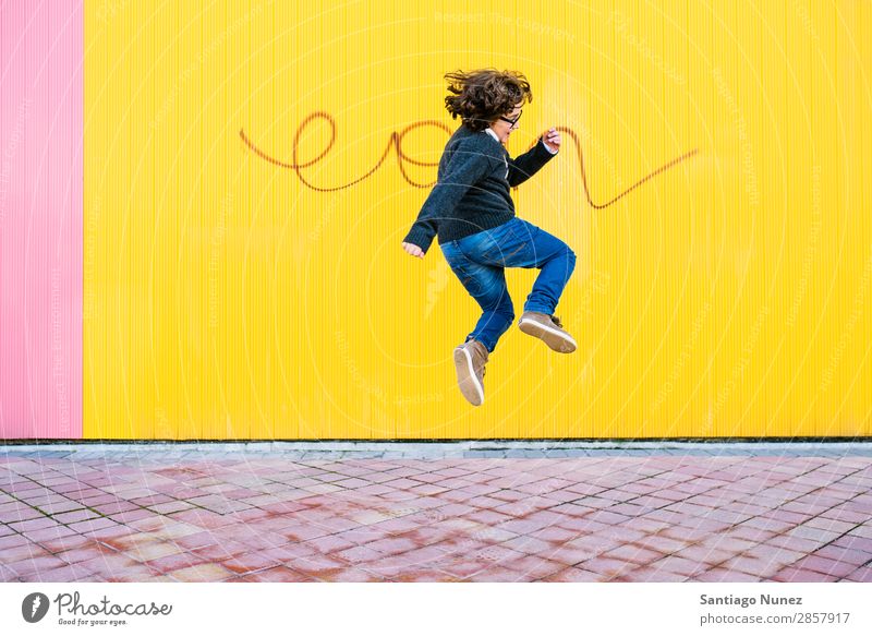 Happy boy jumping. Jump Boy (child) Child Excitement Style Youth (Young adults) Street Town Freestyle Background picture City Man Model Lifestyle Exterior shot