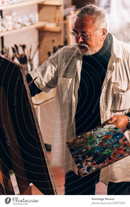 Old man artist painting oils in his studio. Man Adults Beard Artist Painter concentrated Painting and drawing (object) Paintbrush Brush Easel Canvas Concentrate