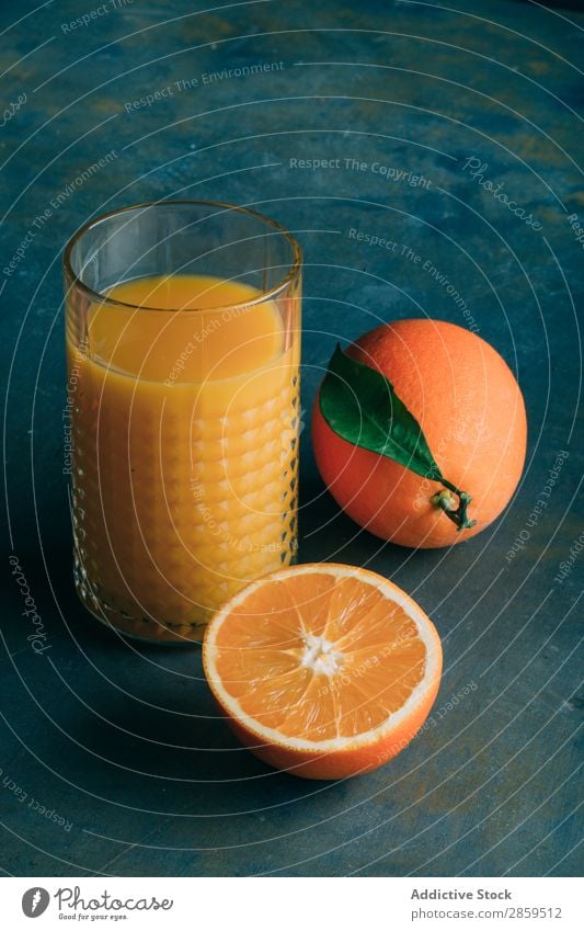 Fresh oranges and glass with orange juice Beverage bio Breakfast Delicious Drinking Fruit Glass Healthy Juice Knives Morning Orange Organic Raw Table Tasty