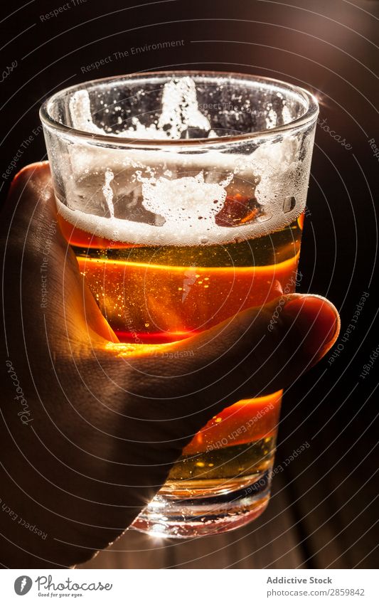 Man's hand holding a glass of berr with light at background Alcoholic drinks ale Bar Beer Beverage Bottle Brewery Cool (slang) Craft (trade) Drinking dry stout