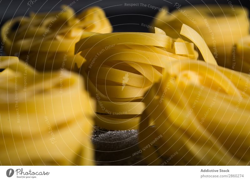 Raw tagliatelle on dark table Background picture Blackboard Board carbohydrate Close-up Dough Dry Egg Flour Food Fresh Healthy Home-made Italian Kitchen