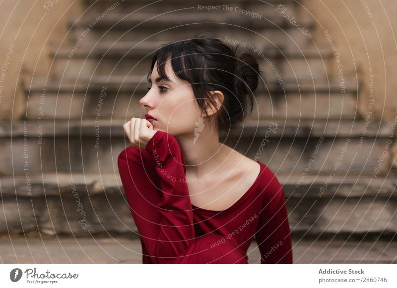 Tender girl in red looking away Woman Vulnerable Beauty Photography Eyes Looking Sit Posture To enjoy Stairs Fashion Red Graceful Considerate tender Delicate