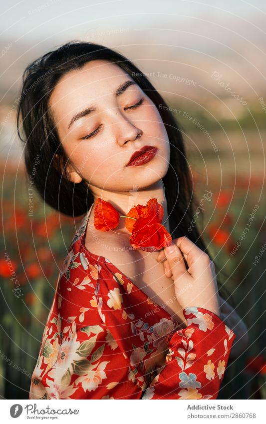 Gorgeous model in red dress holding poppy flowers Woman To enjoy Field Flower Red Dress Recklessness Colour eyes closed Leisure and hobbies Beauty Photography