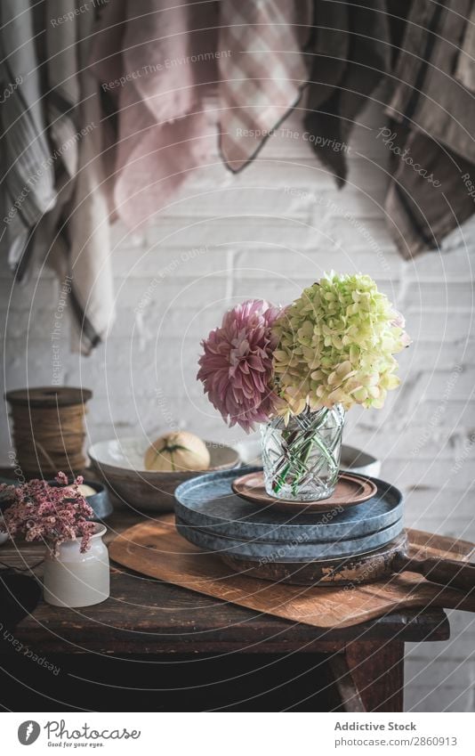 Table with flowers in vase on trays near towels hanging on thread Flower Vase Tray Towel Thread Hanging Chrysanthemum Hydrangea bunch Plant Pan dish cloth Pin