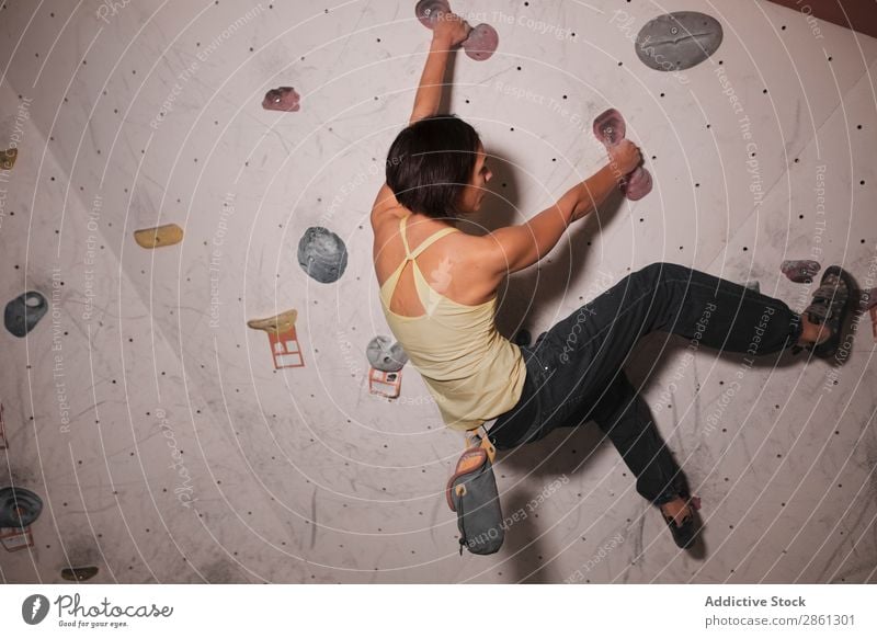 Young woman climbing on wall Woman Climbing Wall (building) Fitness Gymnasium holds Sportswear Lady Youth (Young adults) gymnastic Athletic Action workout Body