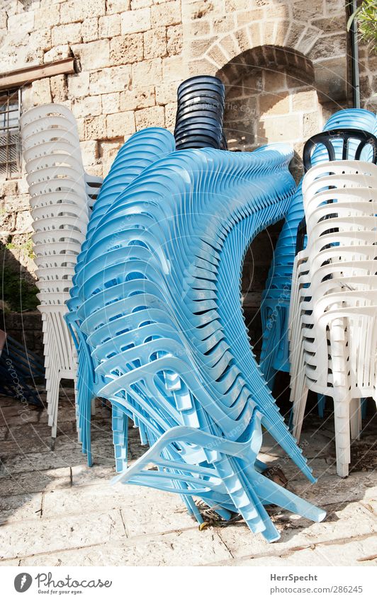 Always these impostors! Chair Jaffa Israel Old town Building Wall (barrier) Wall (building) Stone Plastic Funny Crazy Blue White Plastic chair Stack Mount up