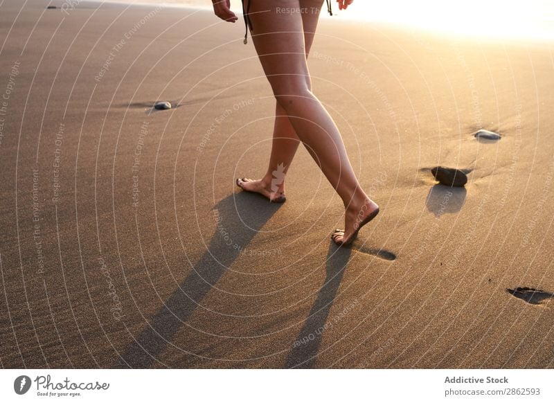 Crop woman strolling on sand of beach Woman Beach Footprint Walking Sand Steps Sunlight Remote Summer Ocean Smooth Coast Footstep Vacation & Travel Barefoot