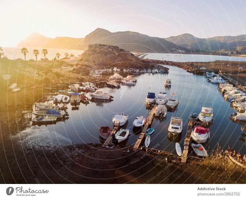 Motorboats in small dock Dock Jetty Watercraft Vacation & Travel Port Nautical Yacht harbour Aircraft drone view Sunlight Ocean Summer Harbour Bay