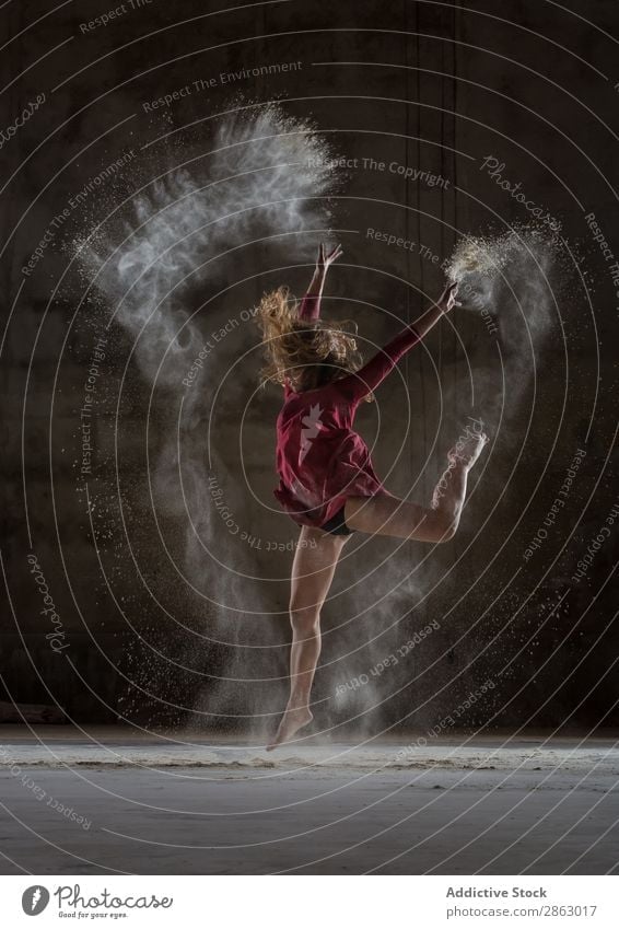 Young woman between fog in darkness Ballet Ballerina Fog Powder Dance Dress Woman Legs Hand upped Performance Room Red Elegant Dark Art pose Shows Smock