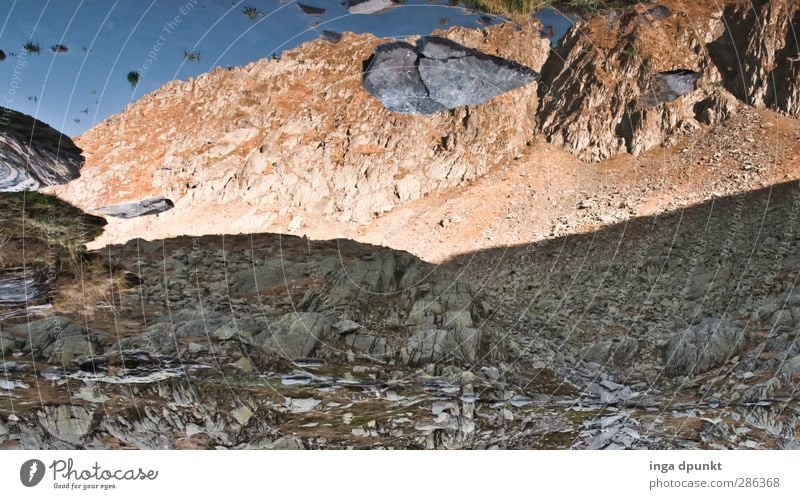 Stones on the horizon Environment Nature Landscape Rock Mountain Desert Gravel Stone wall Adventure Abstract Mirror image Water Lakeside Mountain lake Horizon