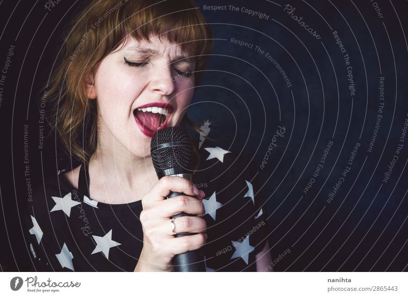 Young woman singing a song with a microphone Face Technology Human being Feminine Youth (Young adults) Woman Adults 1 18 - 30 years Art Punk Music Concert