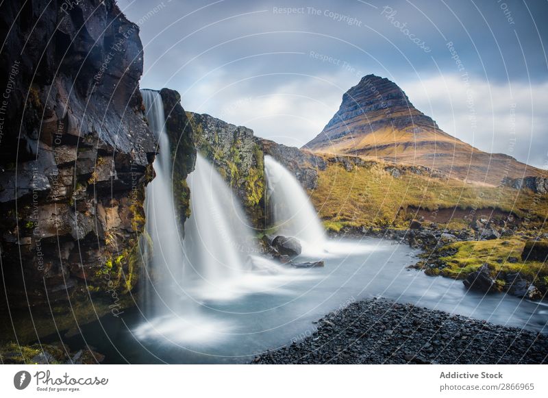 Waterfall between lands of valley Valley Landing Iceland Rapid River Field Picturesque Sky Clouds Surface Vantage point Nature Vacation & Travel Landscape