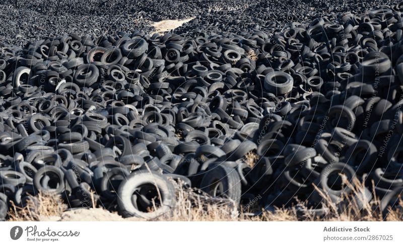 Heap of old tires between field Tire Field huge Car Accumulation Old Sky Beautiful weather Clouds Meadow Rubber Black Stack Second-hand Wheel dump Trash Nature