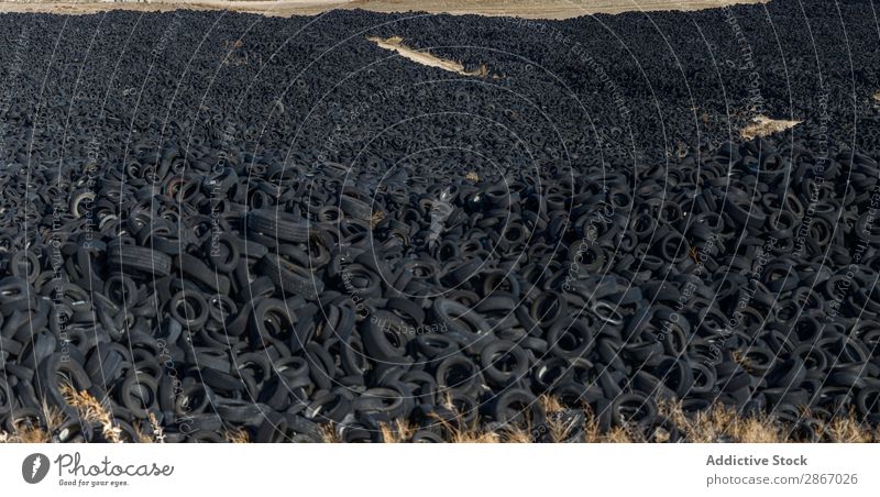 Heap of old tires between field Tire Field huge Car Accumulation Old Sky Beautiful weather Clouds Meadow Rubber Black Stack Second-hand Wheel dump Trash Nature