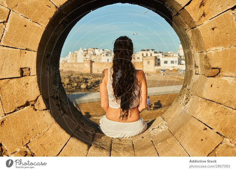 Woman sitting on stone monument near ancient town Stone City Monument Marrakesh Morocco Ancient Rock Town Old Youth (Young adults) Sit Brunette