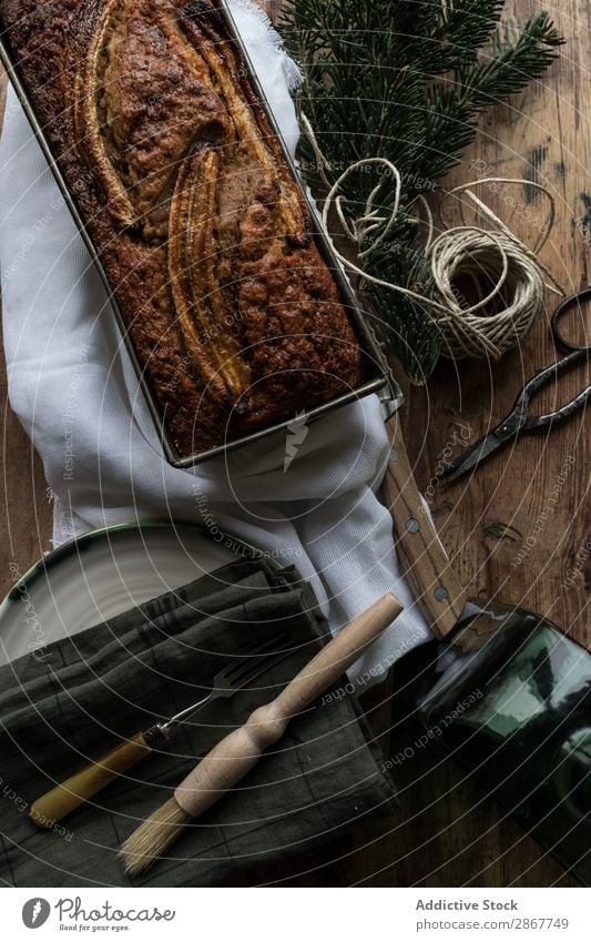 Healthy banana bread on cutting board Bread Banana Chopping board Bakery Container Knives Napkin Baked goods Twig coniferous Thread twist Branch Cake Sweet Food