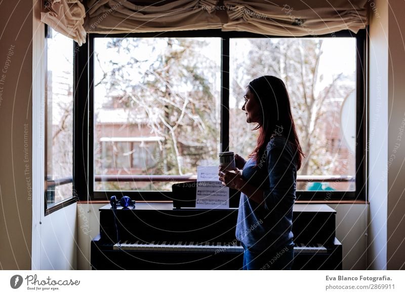 young woman holding a cup of coffee at home Coffee Style Beautiful Leisure and hobbies Playing Music Human being Feminine Young woman Youth (Young adults) Woman