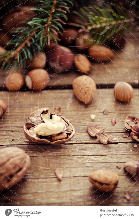 crack nuts Feasts & Celebrations Christmas & Advent Delicious Brown Nut Wooden table Fir branch Hazelnut Almond Walnut Nutshell Food photograph Nut brown