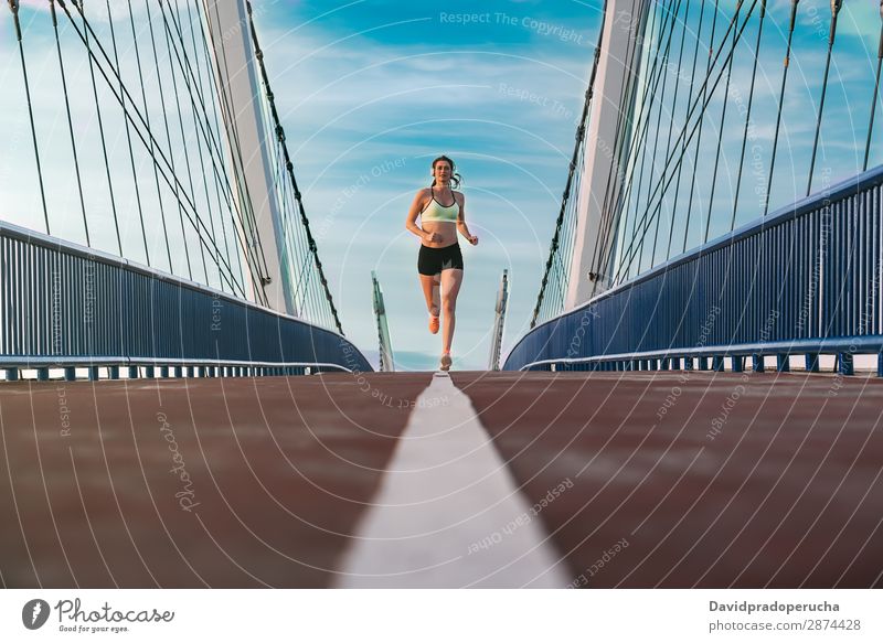Beautiful woman running over bridge Stock Photo