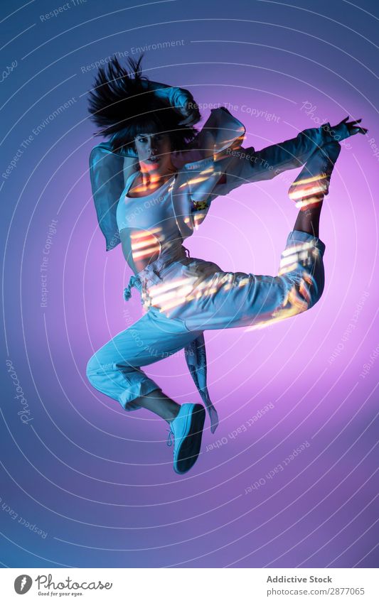 Energetic dancer jumping and looking at camera Dancer Woman Jump Movement Light Youth (Young adults) Modern Style Action Energy Power Contemporary Hip & trendy