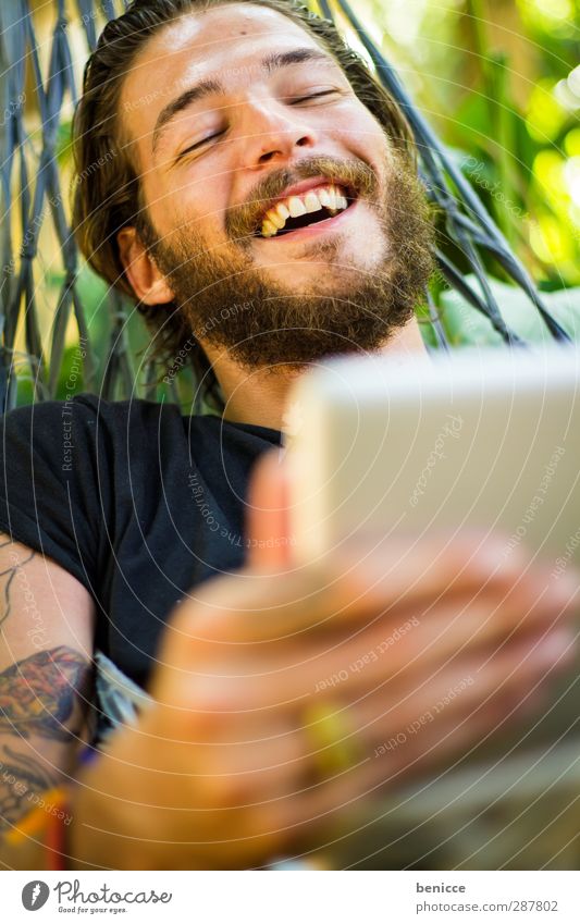 on the tablet Man Human being Young man Facial hair Tablet computer Computer Touchpad Typing Laughter Joy Nature Smiling Internet Tattoo Tattooed Beard Hammock