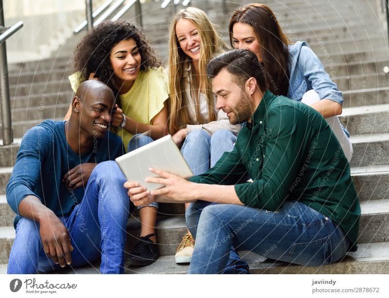 Multi-ethnic group of young people looking at a tablet computer outdoors Lifestyle Joy Happy Beautiful Human being Feminine Young woman Youth (Young adults)