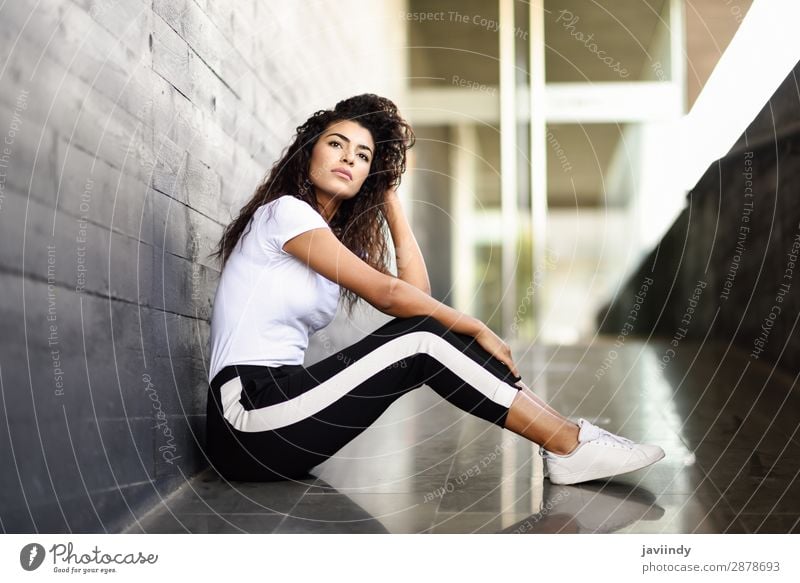 African woman with black curly hairstyle sitting on urban floor. Lifestyle Style Beautiful Hair and hairstyles Face Sports Human being Feminine Young woman
