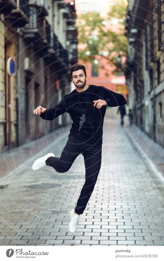 Young man jumping in urban background Lifestyle Style Joy Happy Beautiful Hair and hairstyles Feasts & Celebrations Success Human being Masculine