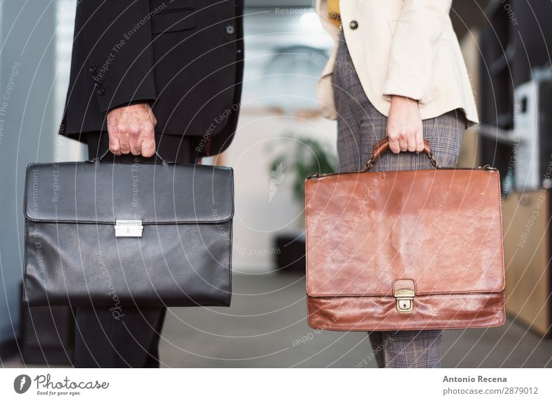 Mature man and young woman with briefcases Work and employment Profession Workplace Office Business Company Human being Woman Adults Man Suit Suitcase Modern