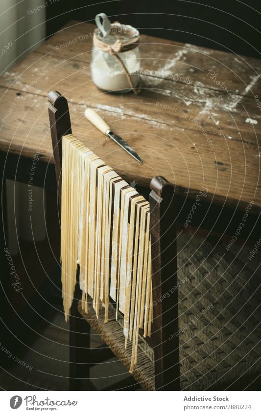 Fresh pasta hanging on chair Pasta Raw Italian Food Cooking Tradition Chair Hanging drying Flour Home-made Meal Healthy Ingredients Spaghetti fettuccine Wheat
