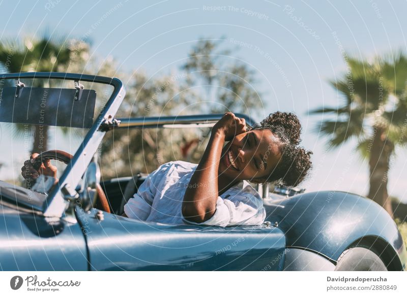 Black woman driving a vintage convertible car Woman Car Driving Ethnic Happy Convertible Street Luxury Looking away Cheerful Smiling Classic 60's Beautiful