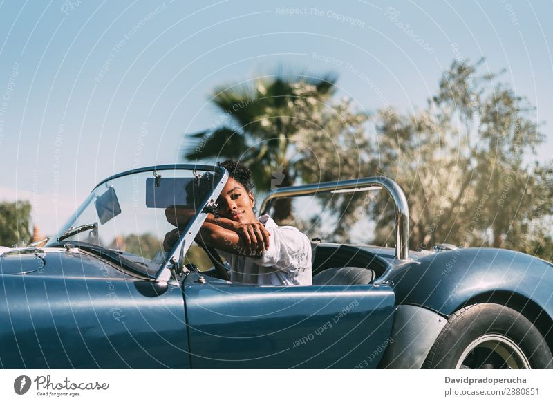 Black woman driving a vintage convertible car Woman Car Driving Ethnic Happy Convertible Street Luxury Looking away Smiling Profile Classic 60's Beautiful