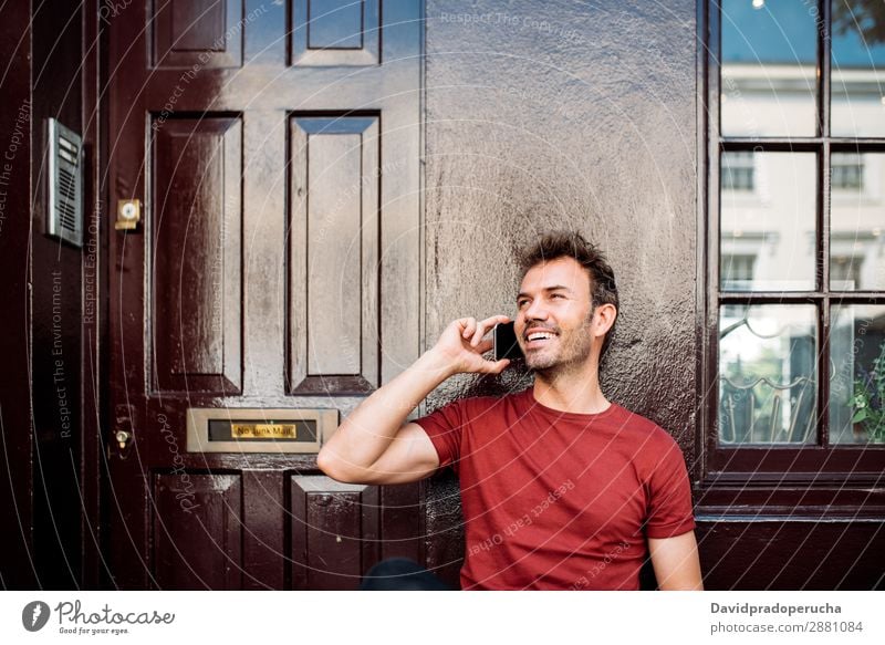 Man sitting in a bench on a beautiful maroon background Cellphone Caucasian Cheerful Building Youth (Young adults) Architecture Technology Vintage Smiling